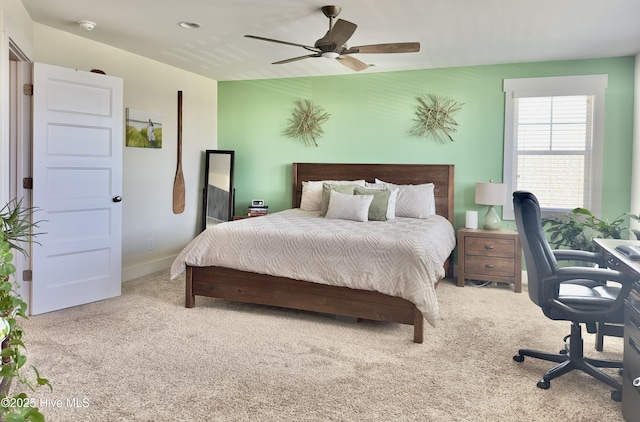 carpeted bedroom featuring baseboards and a ceiling fan