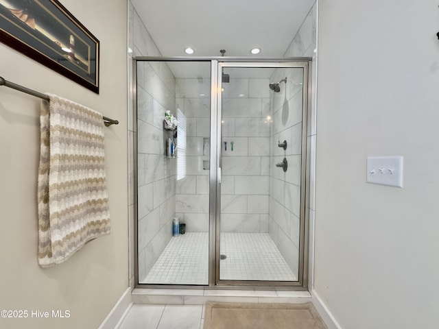 full bathroom featuring baseboards, tile patterned flooring, and a shower stall