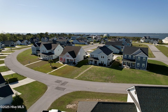 drone / aerial view with a water view and a residential view