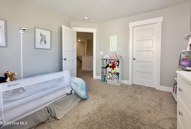 carpeted bedroom featuring baseboards