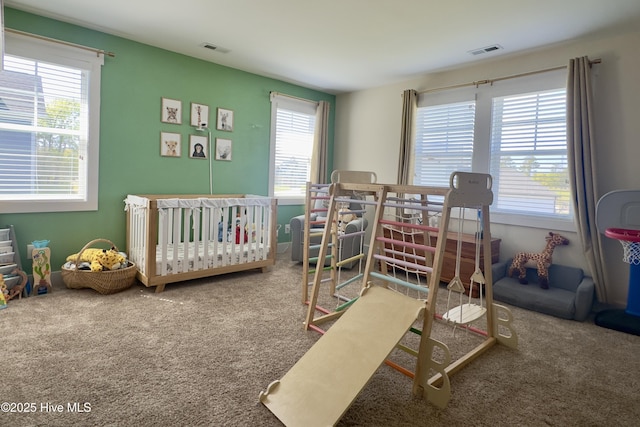 carpeted bedroom featuring visible vents