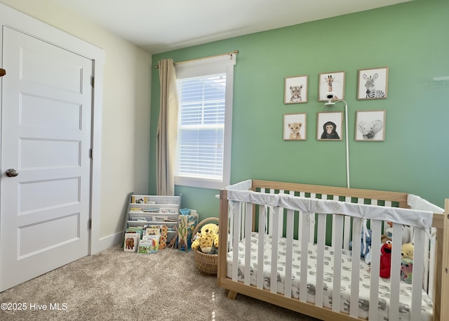bedroom with a nursery area and carpet