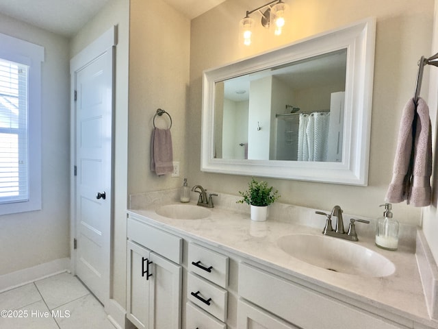 bathroom featuring tile patterned floors, a healthy amount of sunlight, and a sink