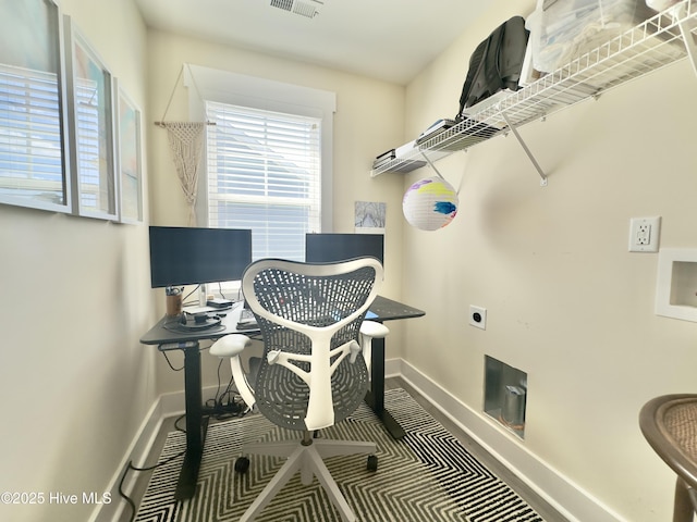 office space featuring baseboards and visible vents