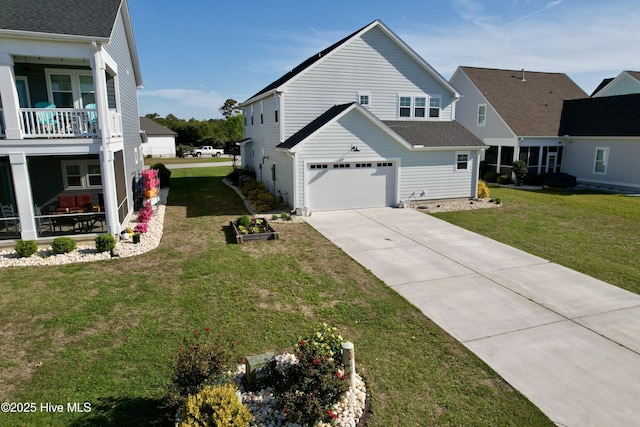 view of side of home featuring a yard, driveway, and a garage