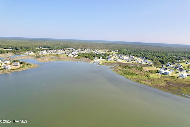 aerial view featuring a wooded view and a water view