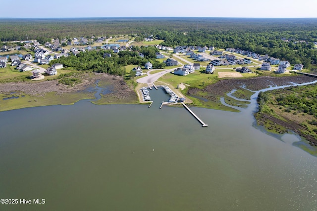 drone / aerial view featuring a water view, a forest view, and a residential view