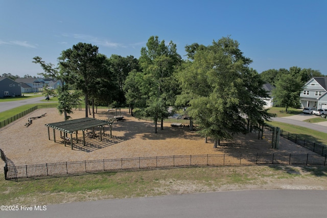 surrounding community with fence and a residential view