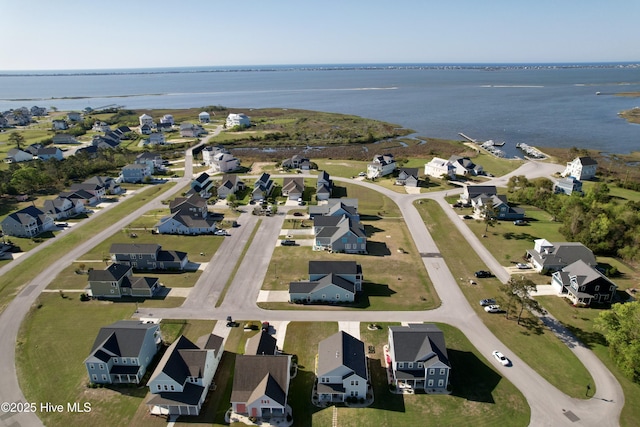 drone / aerial view featuring a water view and a residential view