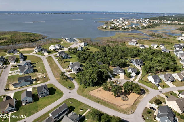 birds eye view of property with a water view and a residential view
