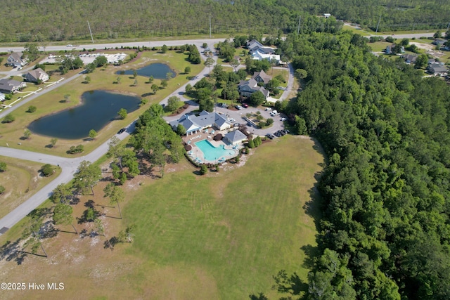 drone / aerial view featuring a water view and a forest view