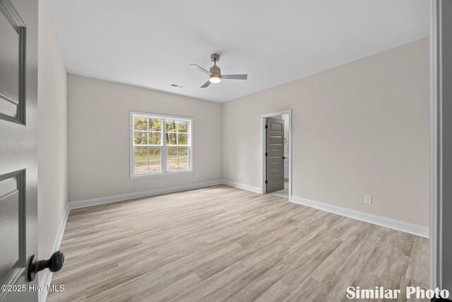 unfurnished living room featuring ceiling fan, wood finished floors, and baseboards