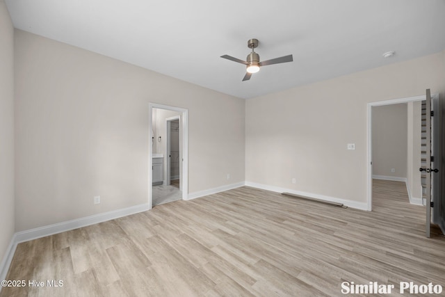 spare room with baseboards, a ceiling fan, and light wood-style floors
