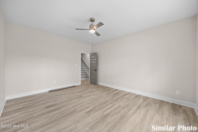 empty room featuring baseboards, a ceiling fan, and wood finished floors