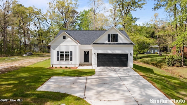 modern farmhouse featuring an attached garage, board and batten siding, driveway, and a front yard