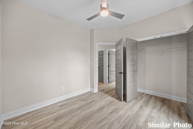 unfurnished bedroom with a closet, light wood-style flooring, ceiling fan, and baseboards