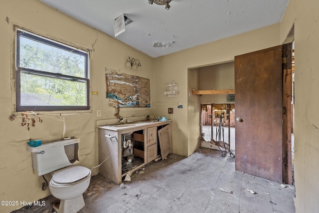 bathroom with visible vents, a textured ceiling, and toilet
