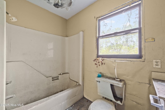 bathroom featuring toilet and bathing tub / shower combination
