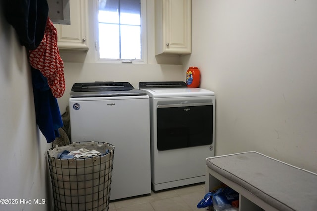 laundry room with light tile patterned flooring, independent washer and dryer, and cabinet space