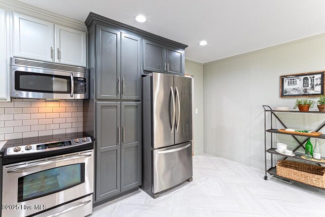 1369 Linden Rd, Aberdeen, NC 28315 - kitchen featuring appliances with stainless steel finishes, tasteful backsplash, baseboards, recessed lighting, and crown molding