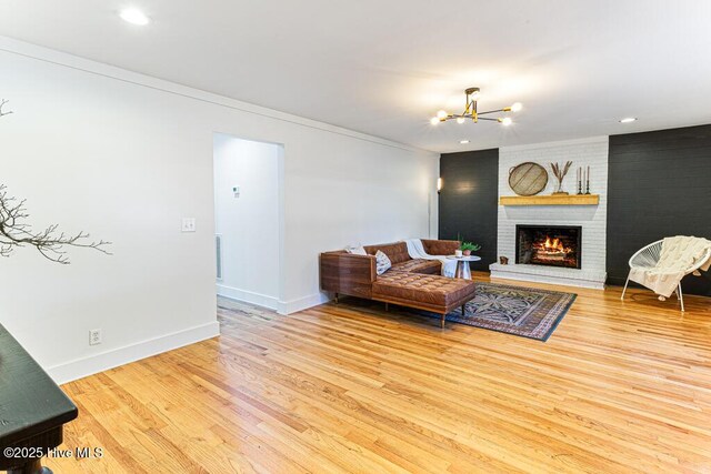 1369 Linden Rd, Aberdeen, NC 28315 - living room with a chandelier, wood finished floors, a fireplace, baseboards, and ornamental molding