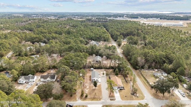 birds eye view of property featuring a wooded view
