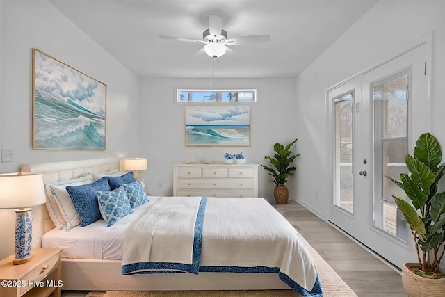 bedroom featuring access to outside, light wood-type flooring, and a ceiling fan