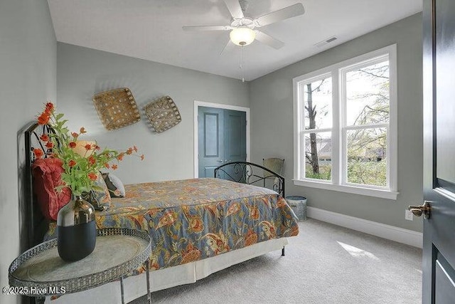 bedroom featuring baseboards, visible vents, ceiling fan, and carpet
