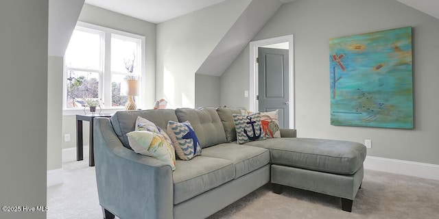 living area featuring baseboards, carpet, and lofted ceiling