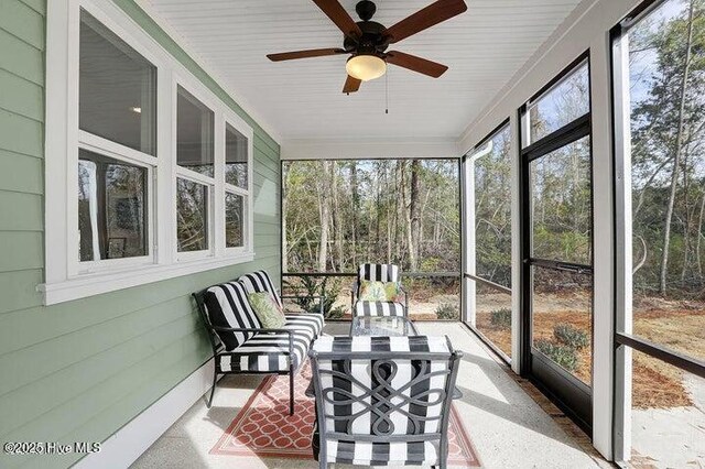 sunroom with a ceiling fan