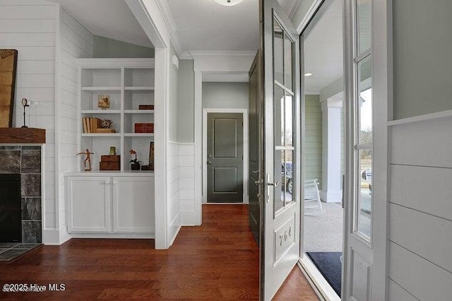 corridor with dark wood-style flooring and crown molding