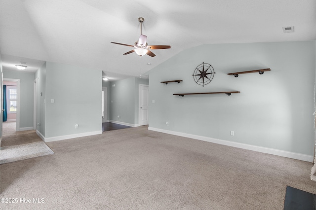 unfurnished living room featuring ceiling fan, visible vents, carpet, baseboards, and vaulted ceiling