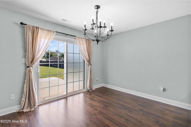 unfurnished dining area with visible vents, baseboards, a chandelier, and dark wood finished floors