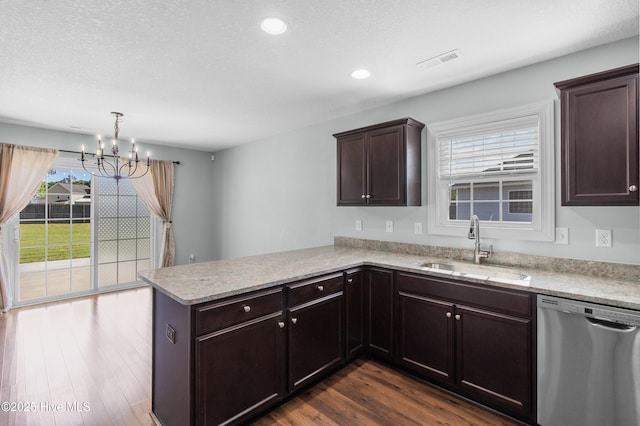 kitchen with an inviting chandelier, a sink, a peninsula, dark wood-type flooring, and stainless steel dishwasher