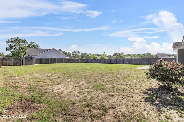 view of yard featuring an outdoor structure, a fenced backyard, and a shed