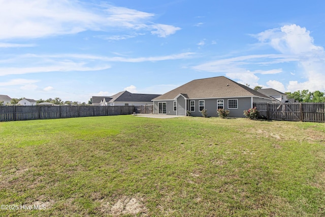 back of house with a lawn, a patio, and a fenced backyard