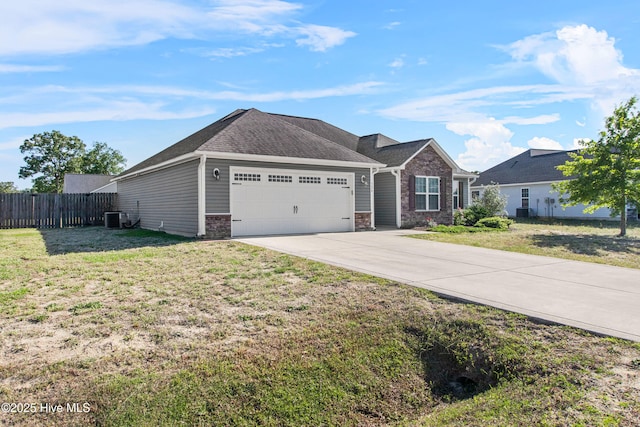 single story home featuring an attached garage, fence, driveway, and a front yard