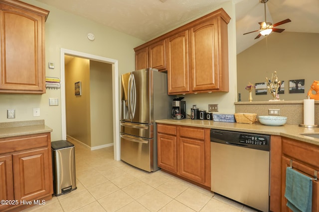 kitchen featuring ceiling fan, appliances with stainless steel finishes, light tile patterned flooring, and light countertops