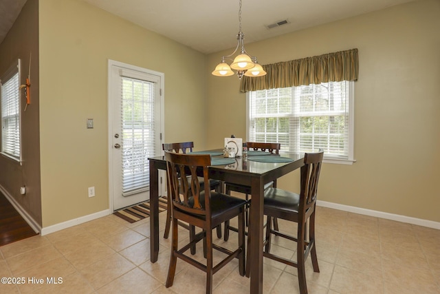 dining area with baseboards, light tile patterned flooring, and visible vents