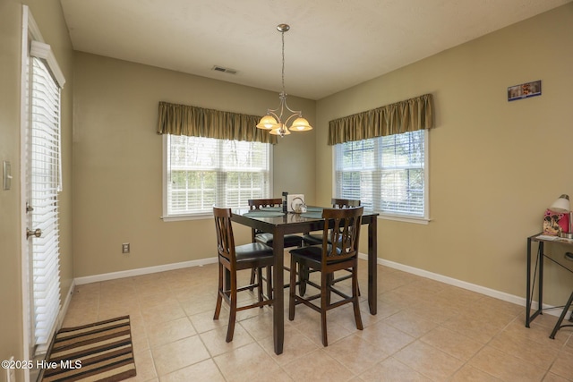 dining area featuring an inviting chandelier, light tile patterned flooring, visible vents, and baseboards