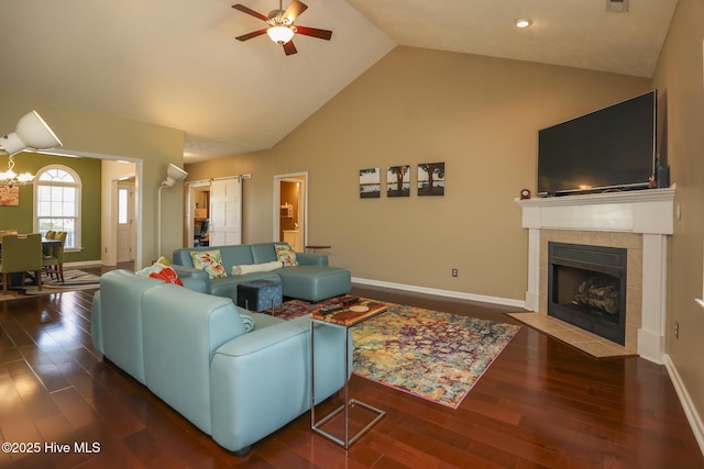 living area featuring wood finished floors, baseboards, and ceiling fan