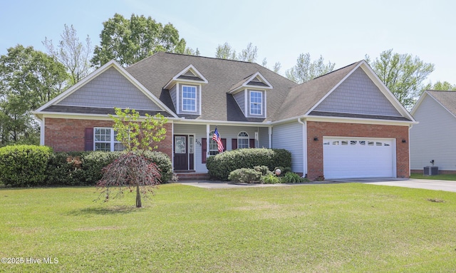 view of front of house with a front lawn, central AC, an attached garage, driveway, and brick siding