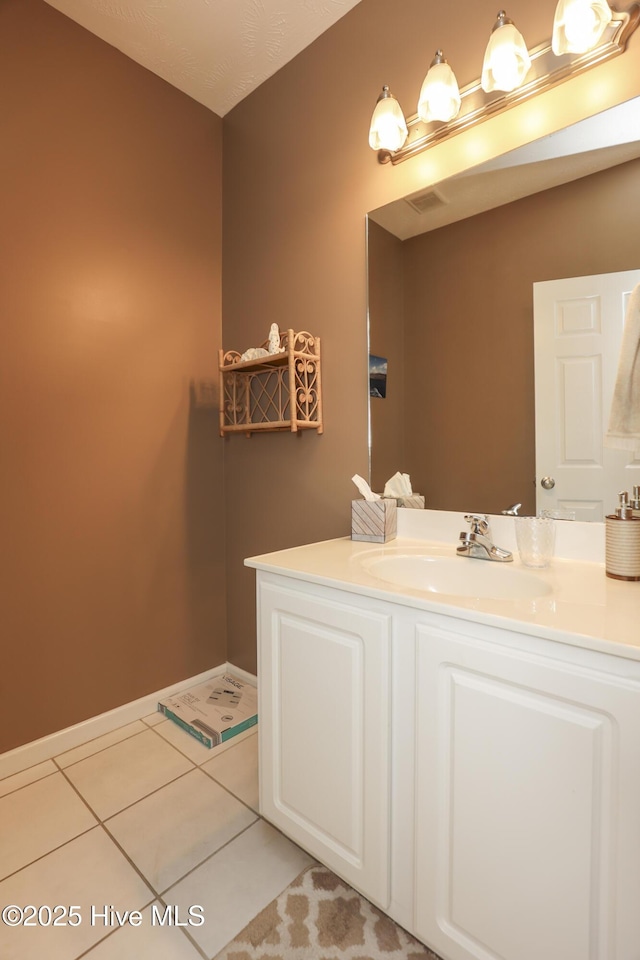 bathroom featuring tile patterned flooring and vanity