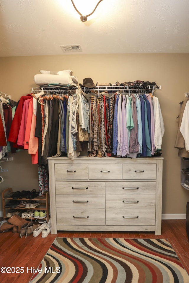 spacious closet featuring wood finished floors and visible vents