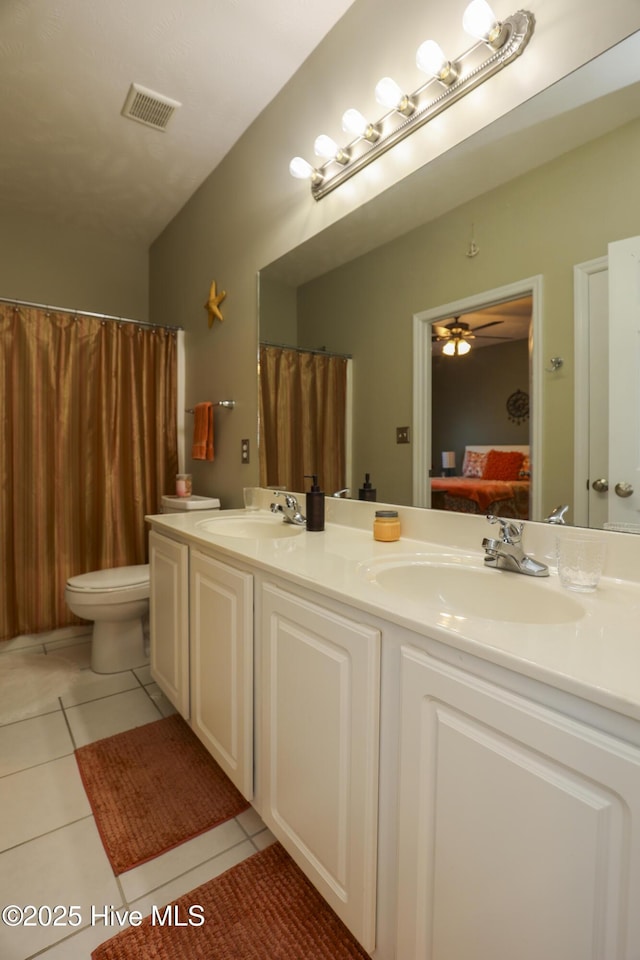 ensuite bathroom with tile patterned flooring, visible vents, a sink, and connected bathroom
