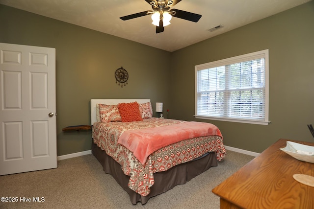 carpeted bedroom featuring visible vents, a ceiling fan, and baseboards