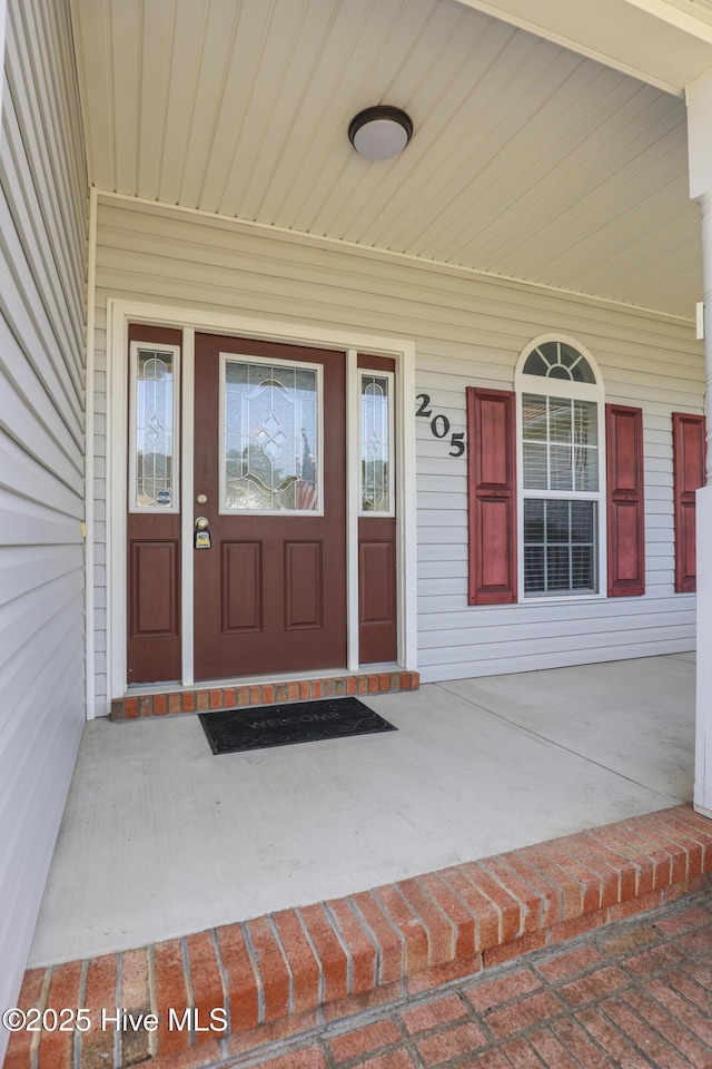 property entrance with covered porch