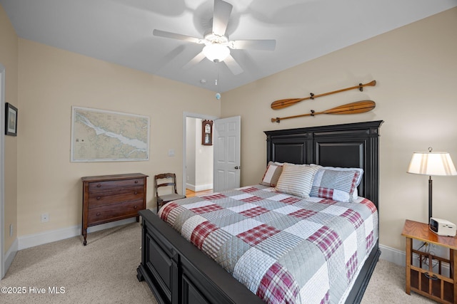 bedroom with baseboards, a ceiling fan, and light colored carpet