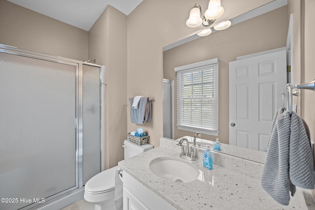 full bath with a shower stall, toilet, vanity, and an inviting chandelier