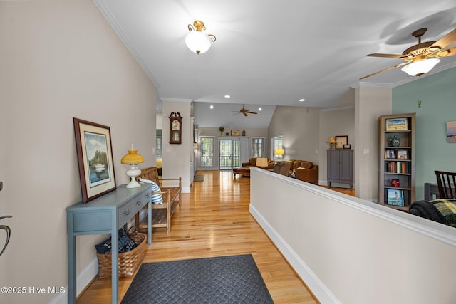 hall with recessed lighting, light wood-style flooring, crown molding, and baseboards